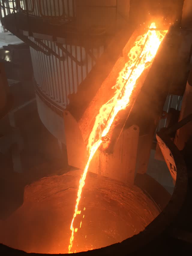 Stream of molten ferro-alloy during furnace tapping